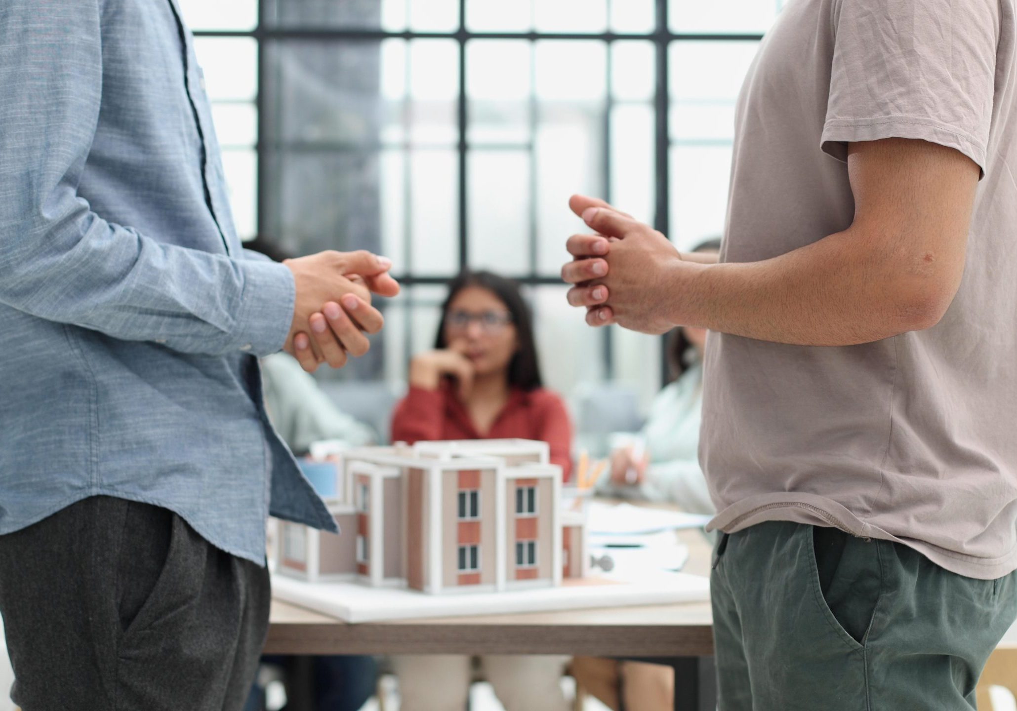Investor in an office discussing property sale options with a client.